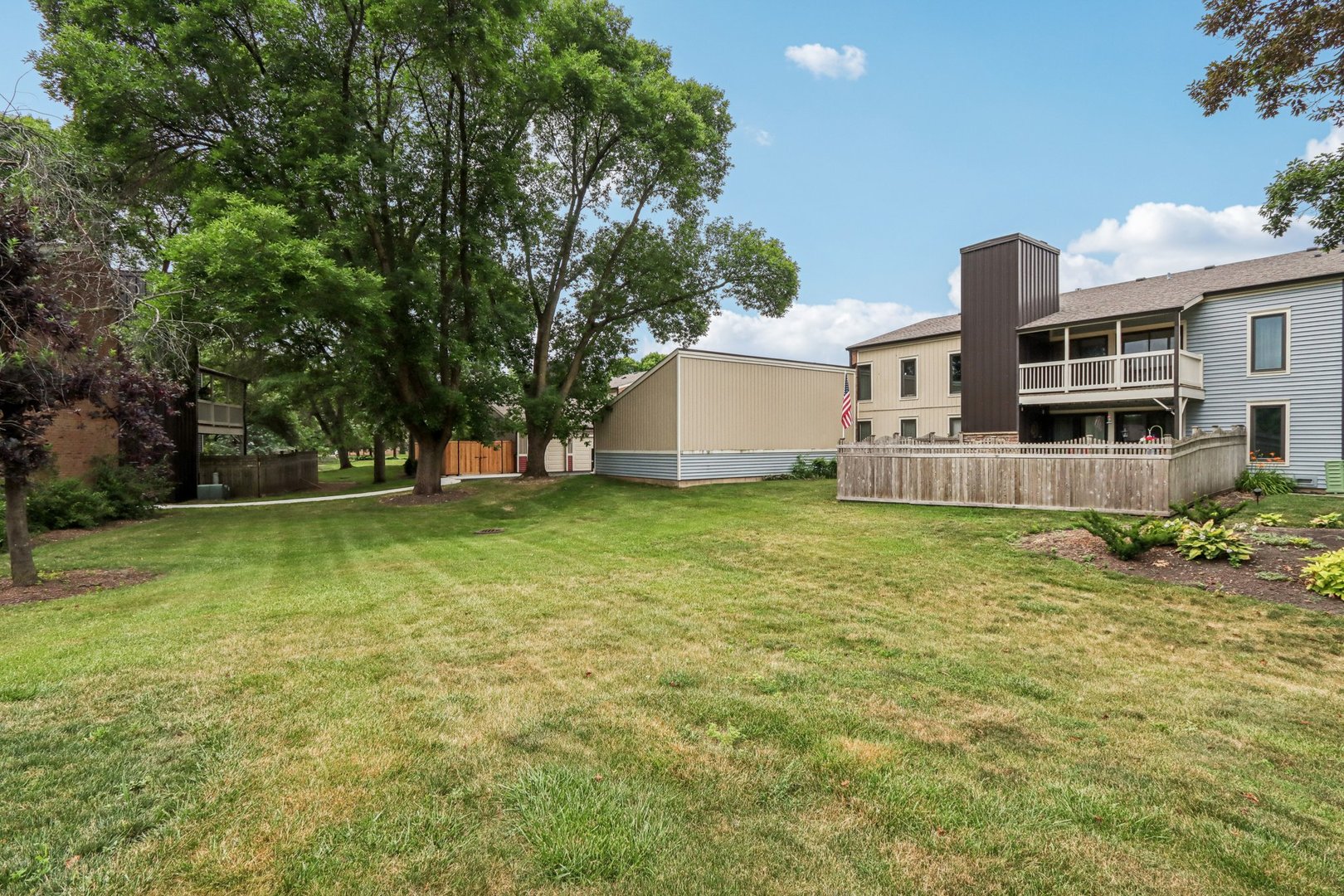 1495 South County Farm Road, Unit 24 Wheaton, IL 60189 - Photo 26 of 26 a view of a house with a yard and sitting area