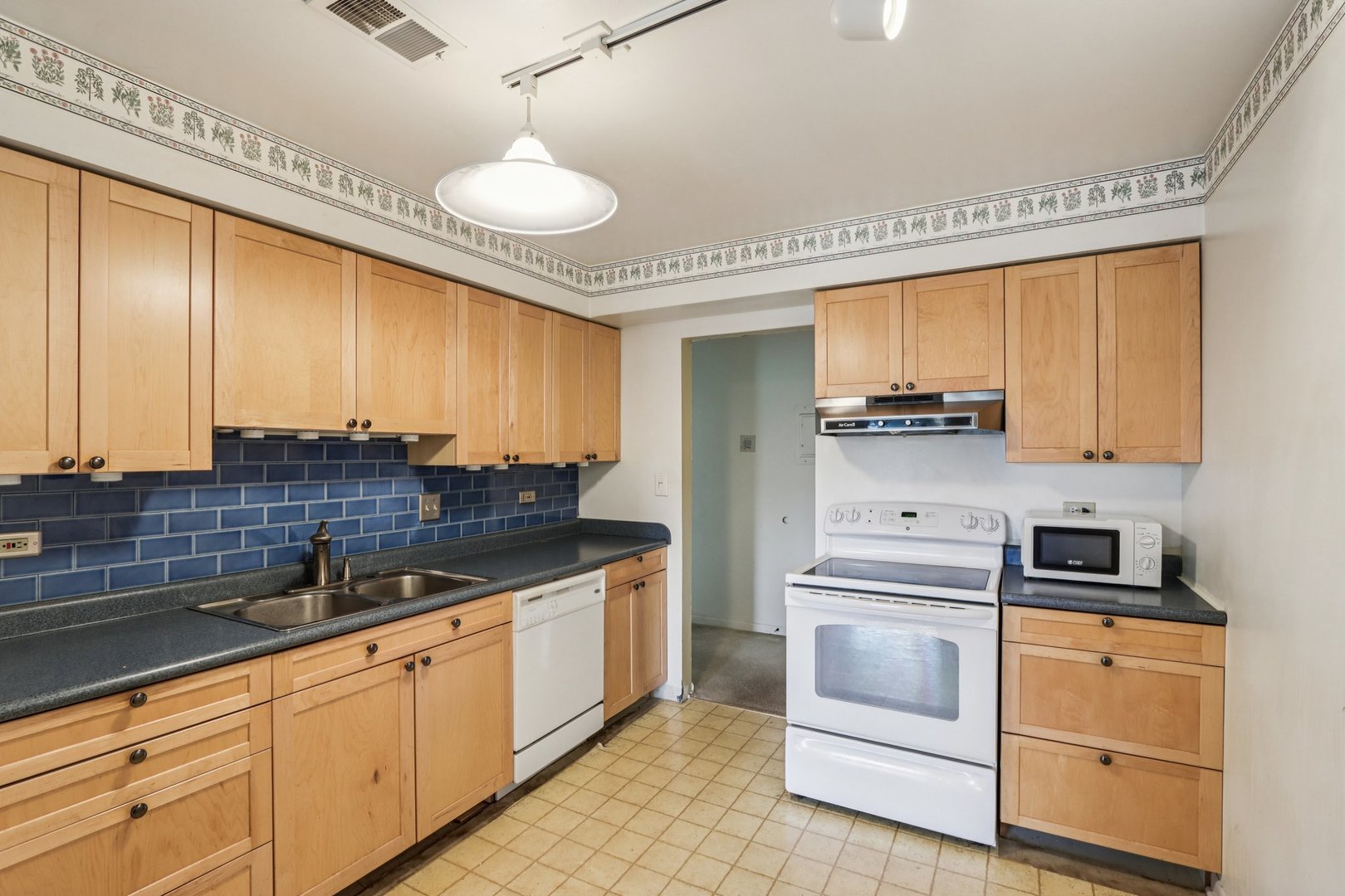 1495 South County Farm Road, Unit 24 Wheaton, IL 60189 - Photo 5 of 26 a kitchen with stainless steel appliances a stove a sink and cabinets