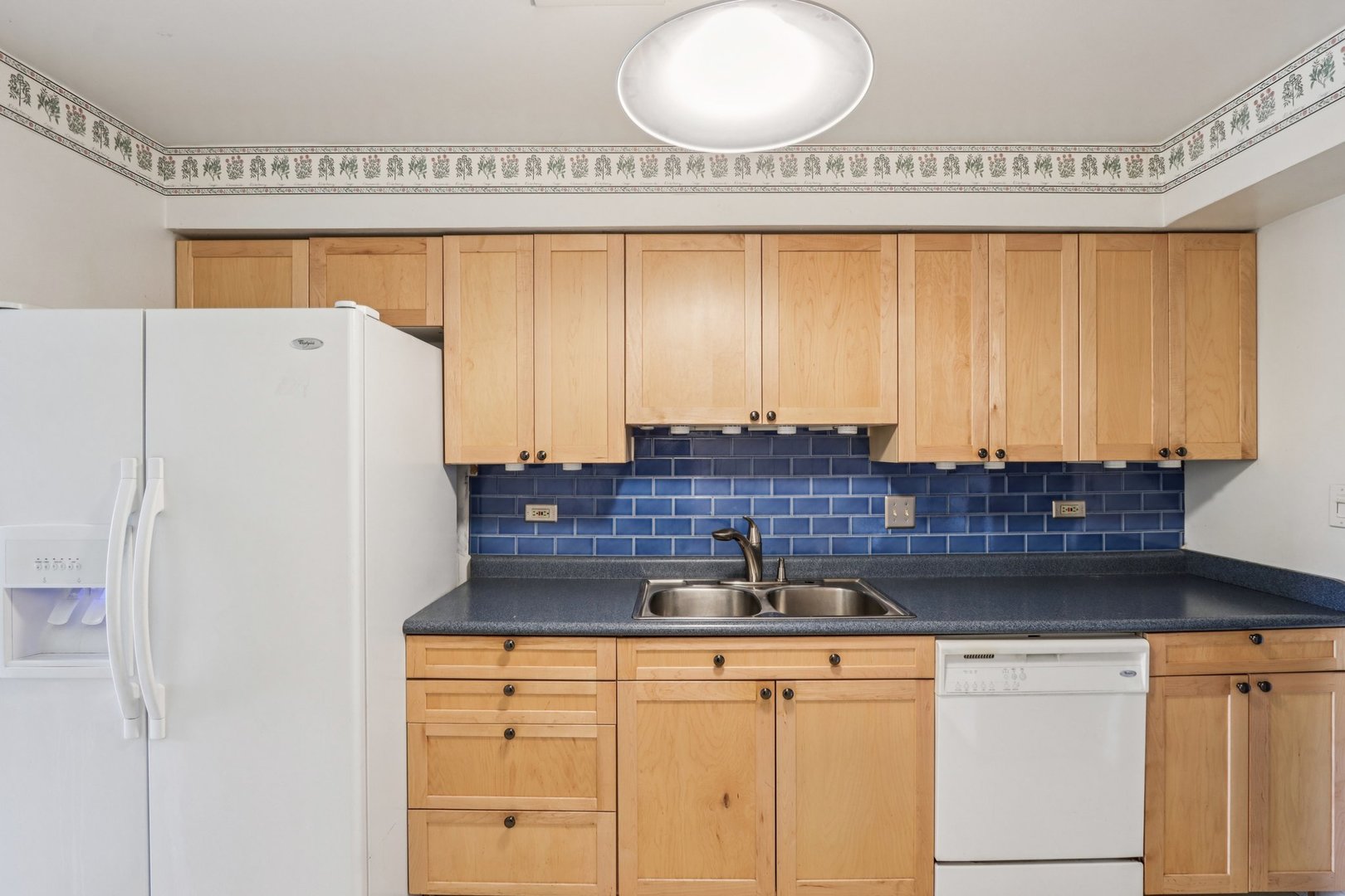 1495 South County Farm Road, Unit 24 Wheaton, IL 60189 - Photo 6 of 26 a kitchen with stainless steel appliances granite countertop a refrigerator and a stove