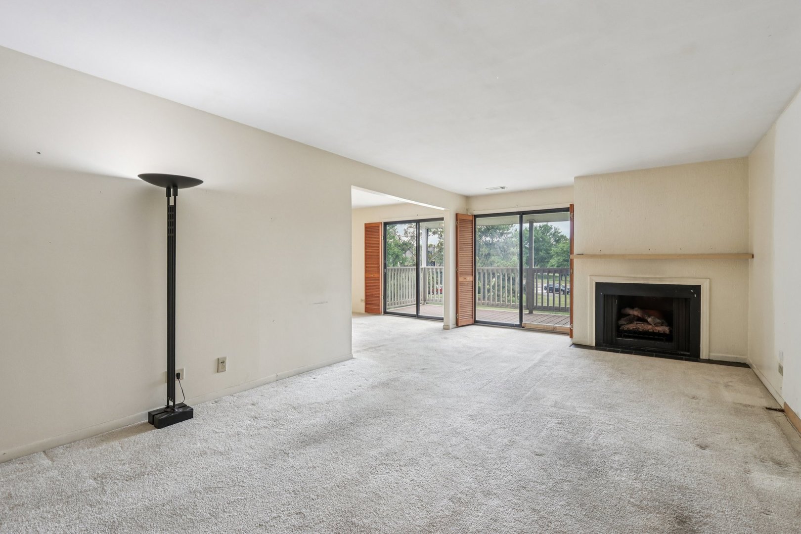 1495 South County Farm Road, Unit 24 Wheaton, IL 60189 - Photo 7 of 26 a view of an empty room with a fireplace and a window