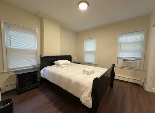 a bedroom with a bed and a window