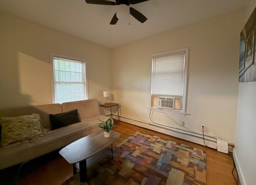 20 Pompeii Street, Unit 2 Boston, MA 02119 - Photo 4 of 8 a living room with furniture and a rug
