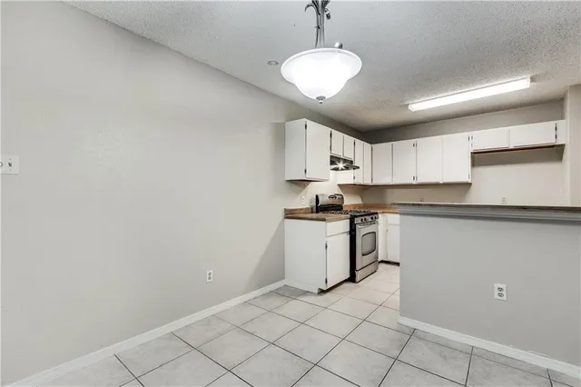 a kitchen with a refrigerator a stove a microwave and cabinets