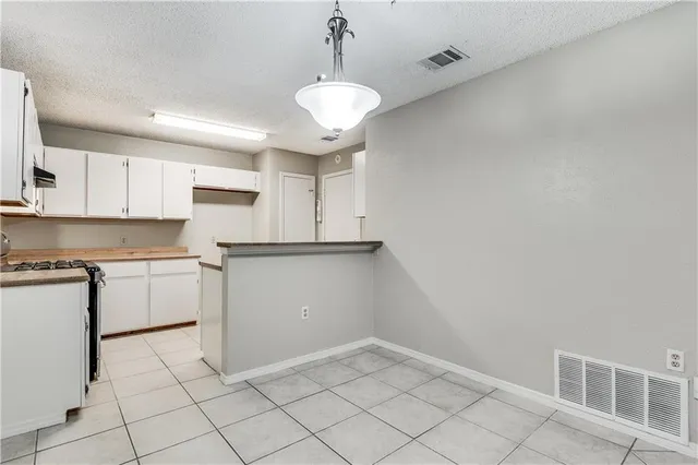 a kitchen with cabinets and window