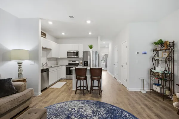a kitchen with granite countertop a sink a stove and cabinets