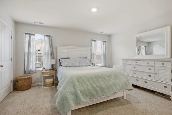 a bedroom with a bed and a mirror