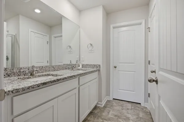 a bathroom with a glass shower door