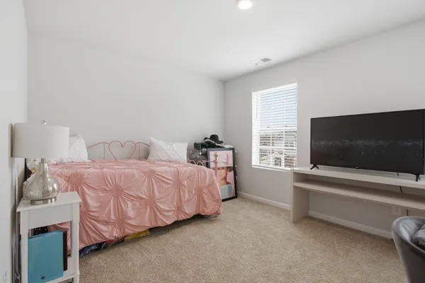 a view of a workspace with a flat screen tv and a window