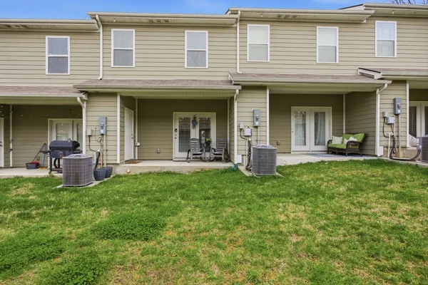 a view of a house with a wooden fence