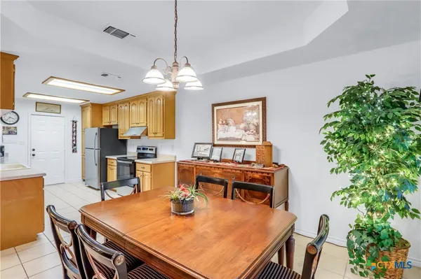a view of a dining room with furniture and chandelier