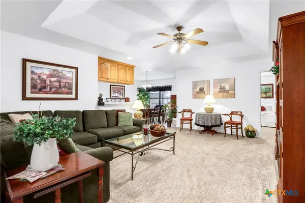 a living room with furniture and a chandelier