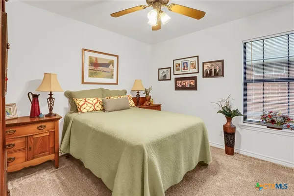 a bedroom with bed and window