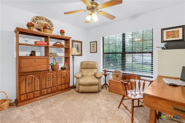 a living room with furniture a window and a chandelier