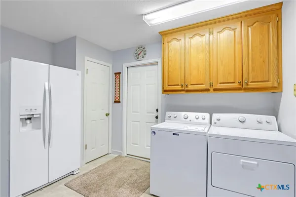 a view of storage and utility room with washer and dryer