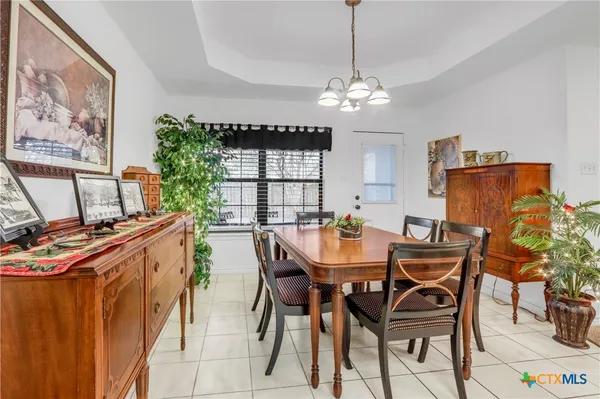 a view of a dining room with furniture and chandelier