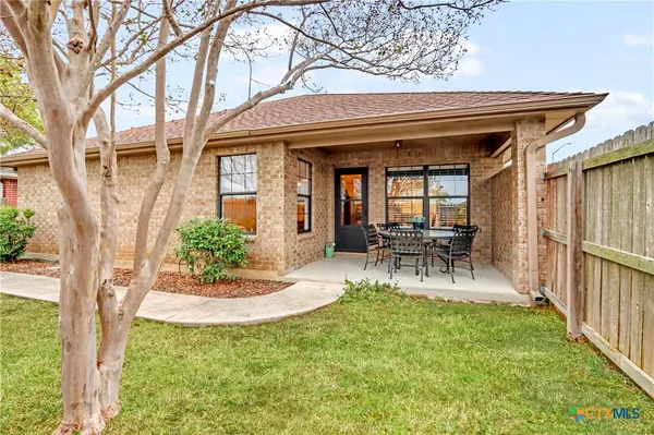 a view of a house with backyard porch and sitting area