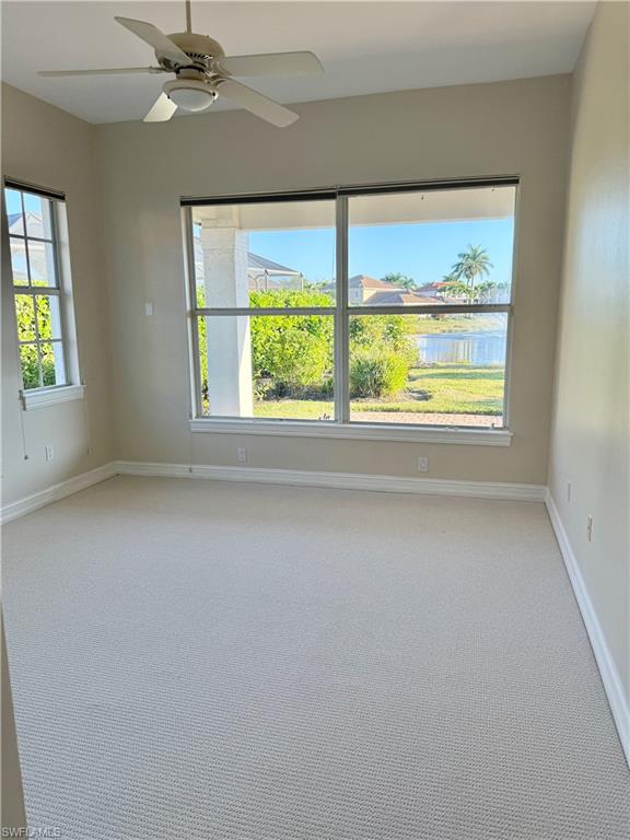 5031 Rustic Oaks Circle Naples, FL 34105 - Photo 12 of 15 Unfurnished room with light colored carpet and a ceiling fan