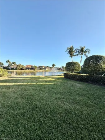 a view of a lake with houses in the back