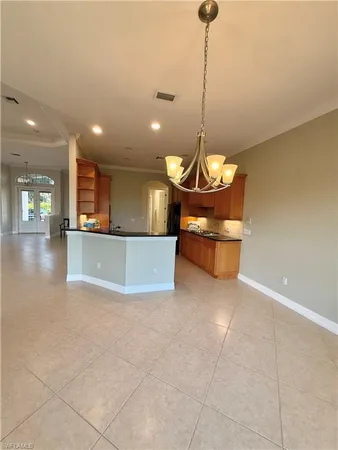 a view of a kitchen with a sink and a chandelier
