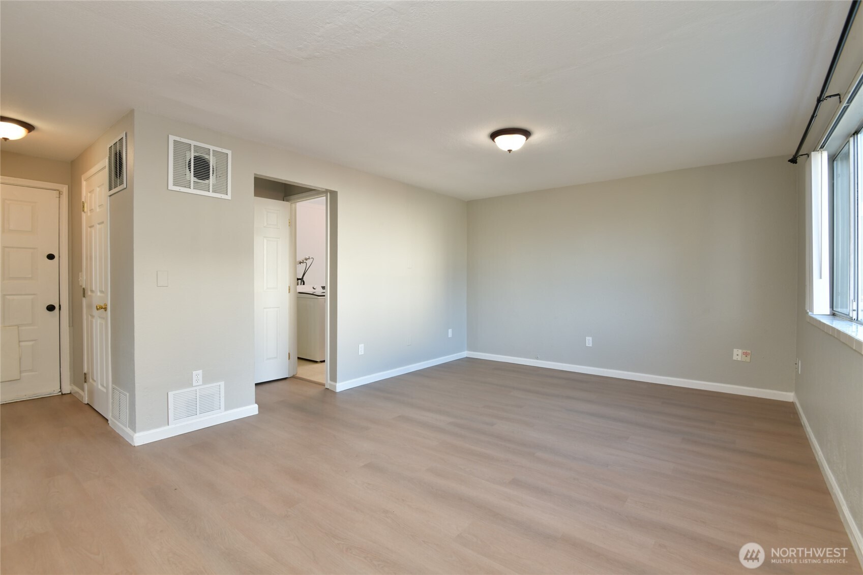1702 South G Street Tacoma, WA 98405 - Photo 4 of 25 an empty room with wooden floor and windows