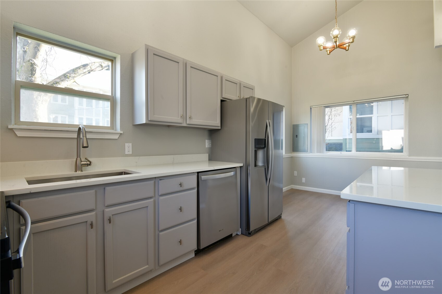 1702 South G Street Tacoma, WA 98405 - Photo 10 of 25 a kitchen with a refrigerator a sink and dishwasher with wooden floor