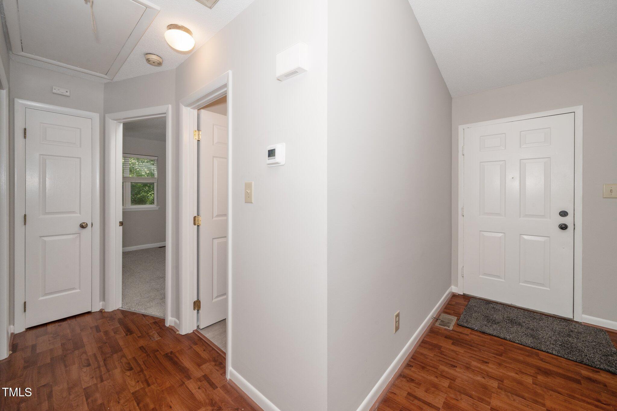 6016 Farm Gate Road Raleigh, NC 27606 - Photo 14 of 23 a view of hallway with closet and wooden floor