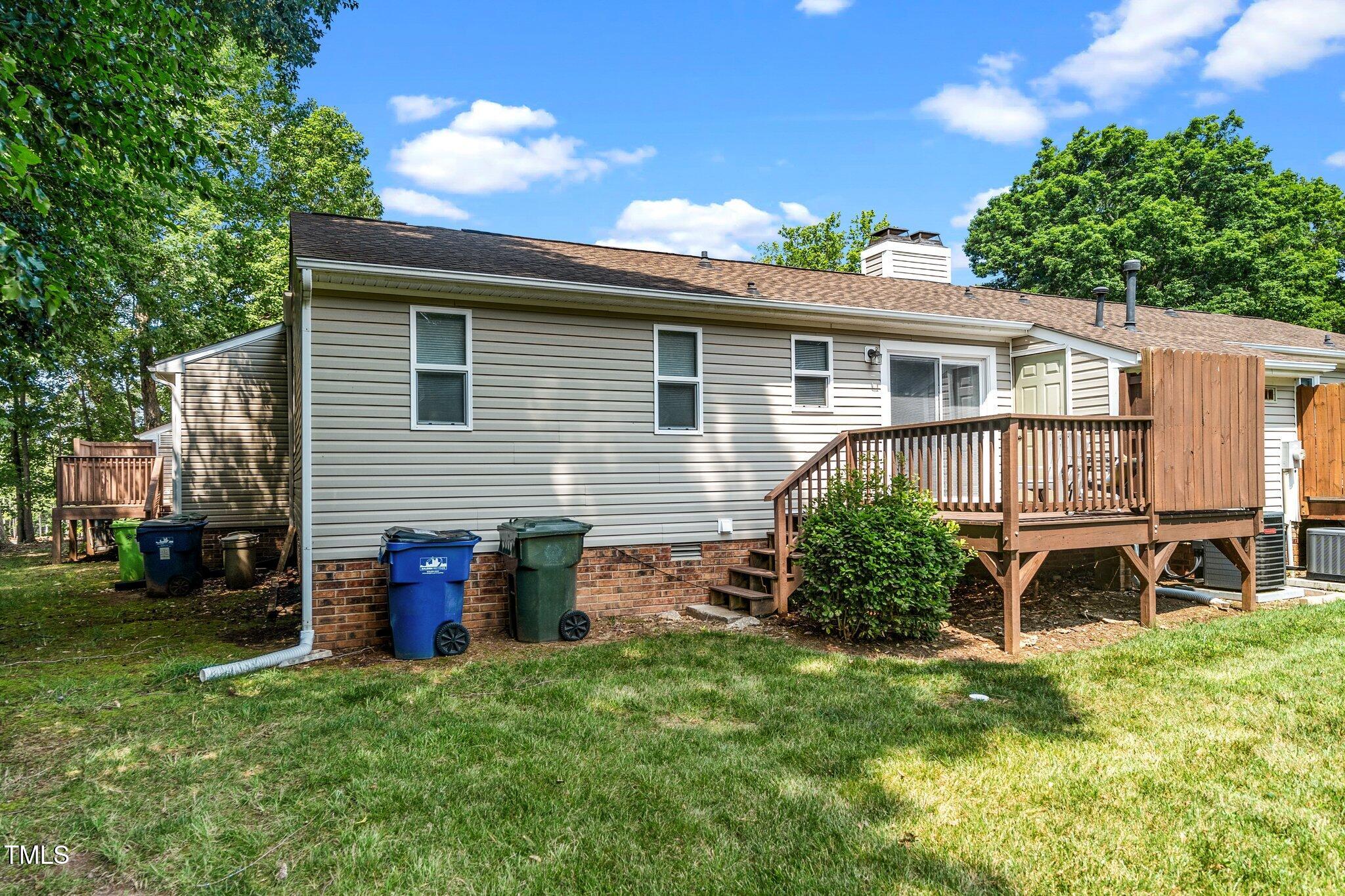 6016 Farm Gate Road Raleigh, NC 27606 - Photo 17 of 23 a backyard of a house with table and chairs