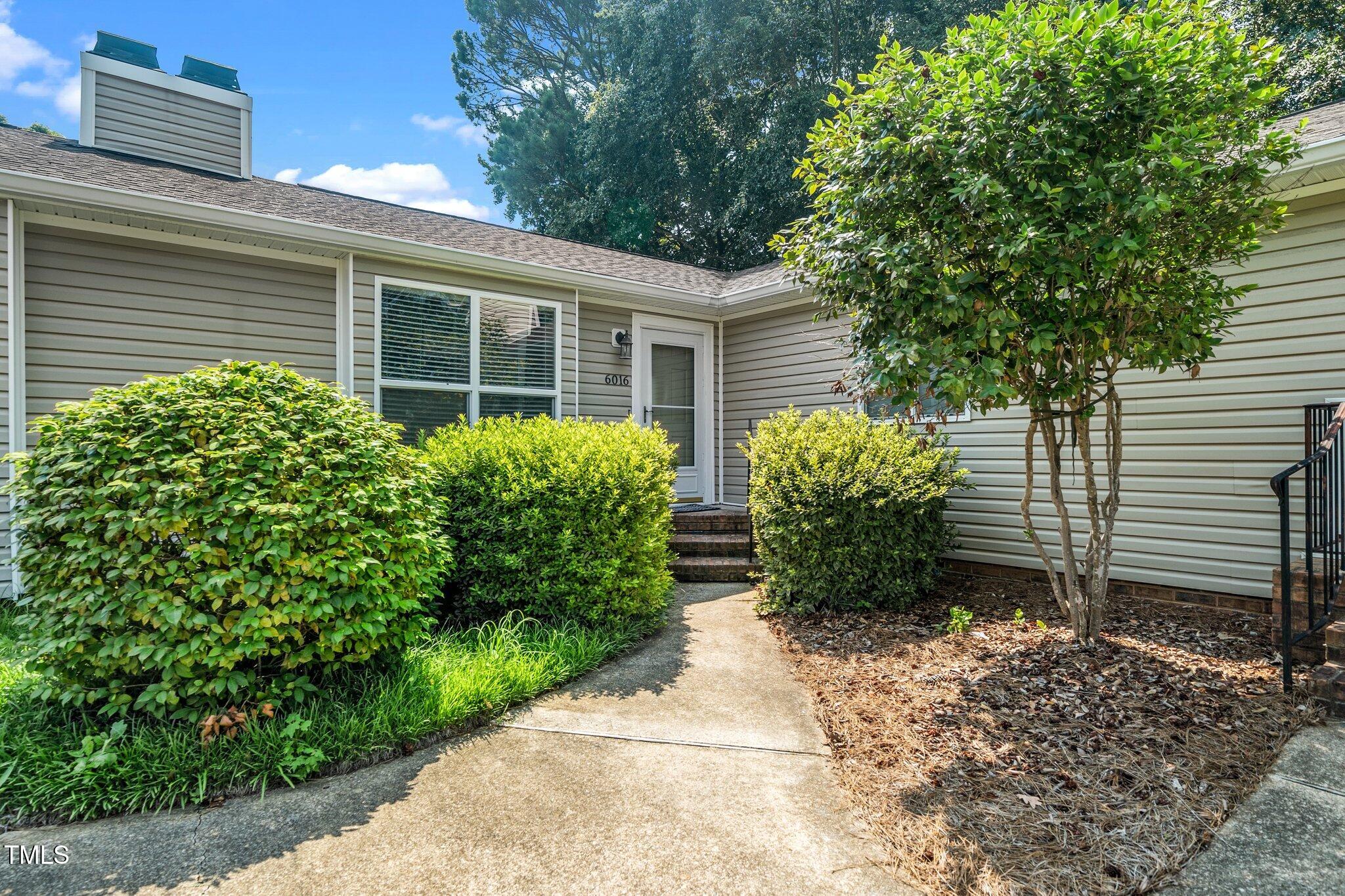 6016 Farm Gate Road Raleigh, NC 27606 - Photo 2 of 23 a view of a backyard with potted plants