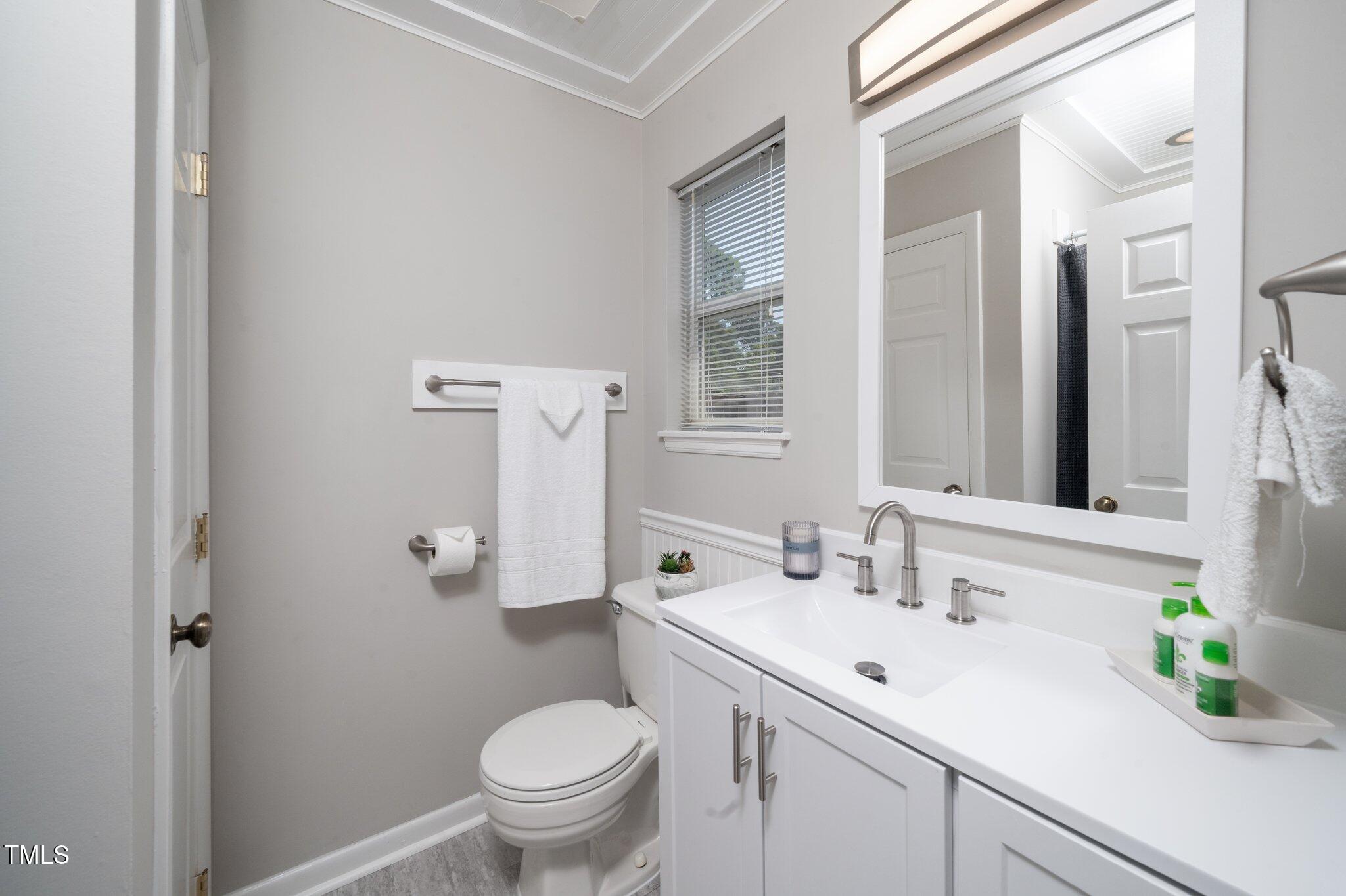 6016 Farm Gate Road Raleigh, NC 27606 - Photo 7 of 23 a bathroom with a sink toilet and a mirror