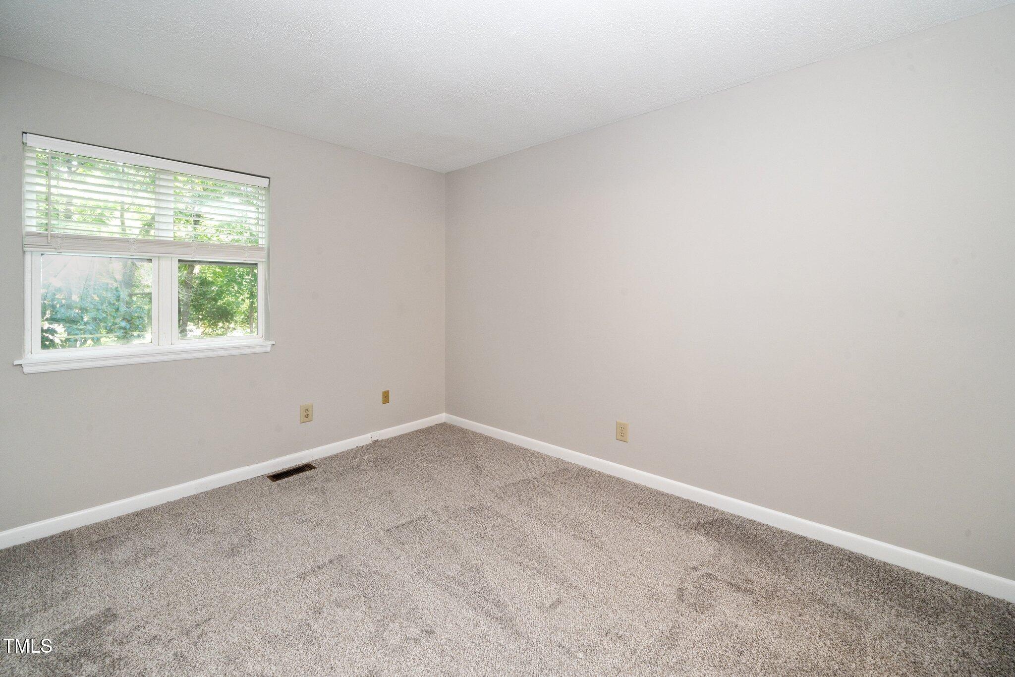 6016 Farm Gate Road Raleigh, NC 27606 - Photo 8 of 23 an empty room with a window