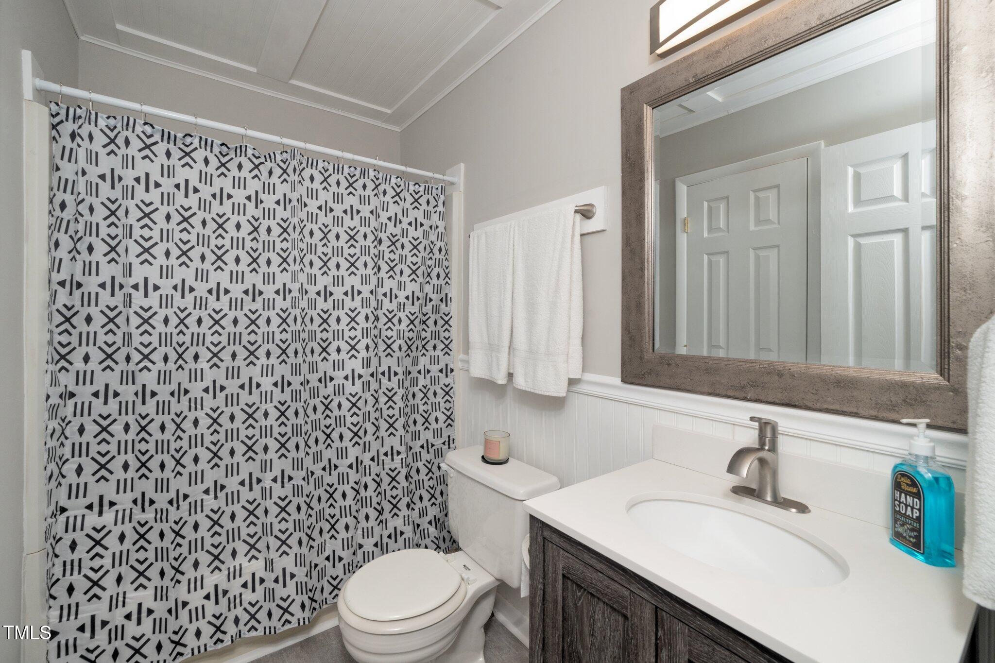 6016 Farm Gate Road Raleigh, NC 27606 - Photo 9 of 23 a bathroom with a sink toilet and shower