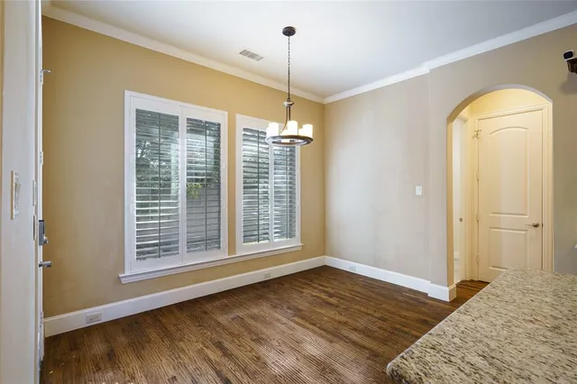 a view of a room with wooden floor and window