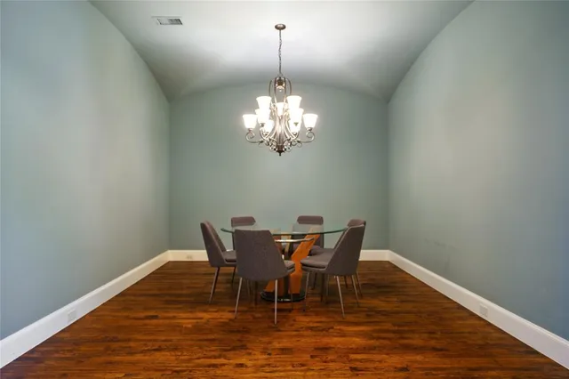 a dining room with furniture and chandelier