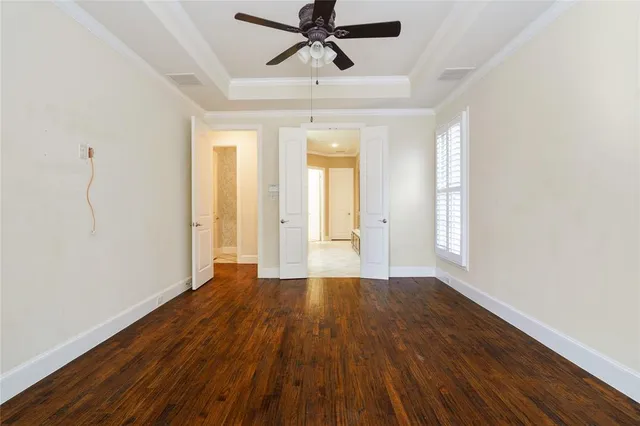 wooden floor in an empty room with a window