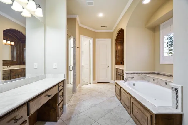 a spacious bathroom with a bathtub sink and mirror