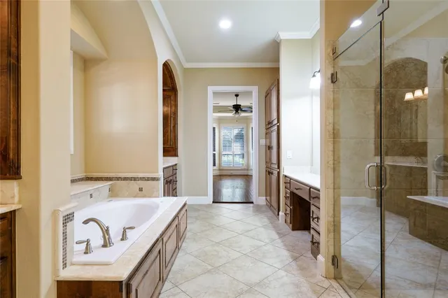 a spacious bathroom with a tub sink and mirror