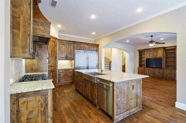 a kitchen with stainless steel appliances granite countertop a stove and a refrigerator