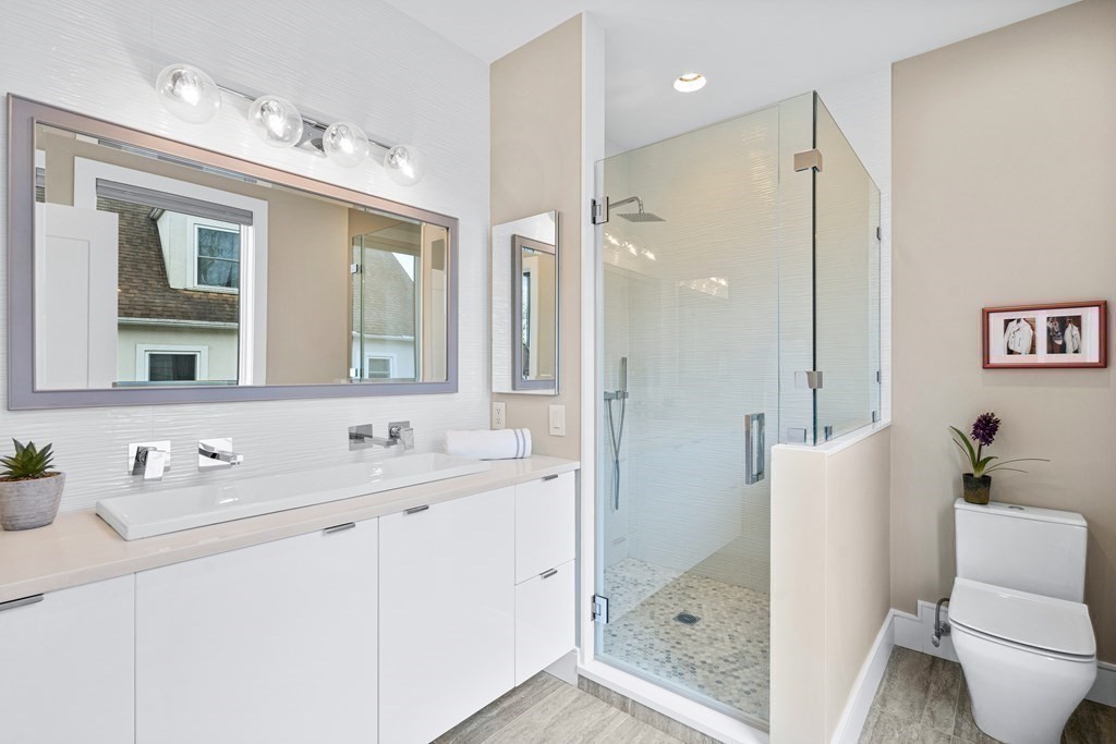 26 Salisbury Road, Unit 26 Newton, MA 02458 - Photo 11 of 27 a bathroom with a double vanity sink mirror and shower