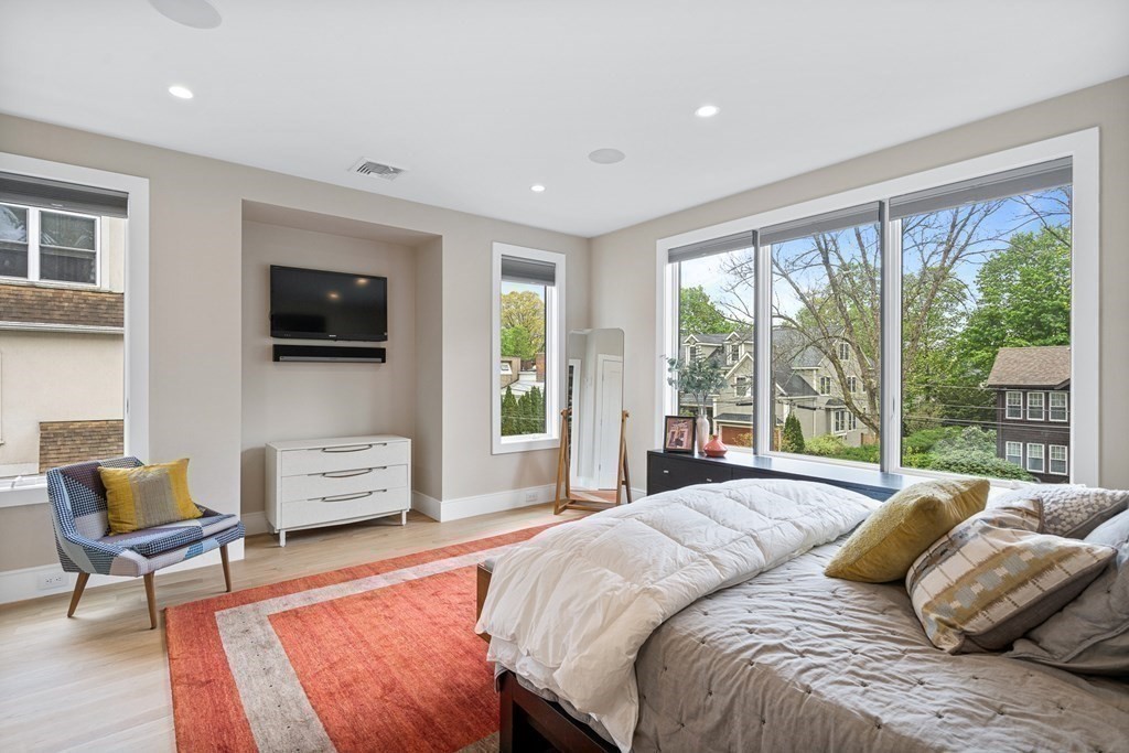 26 Salisbury Road, Unit 26 Newton, MA 02458 - Photo 13 of 27 a bedroom with a bed a couch and a flat screen tv