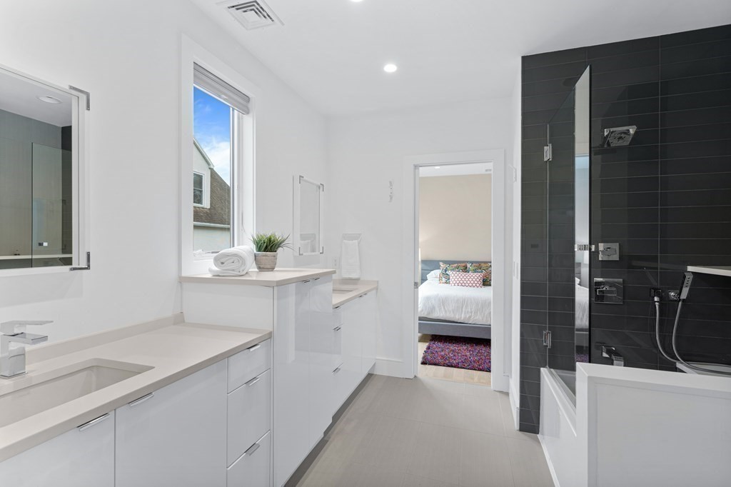 26 Salisbury Road, Unit 26 Newton, MA 02458 - Photo 9 of 27 a en suite bathroom with a sink and a mirror