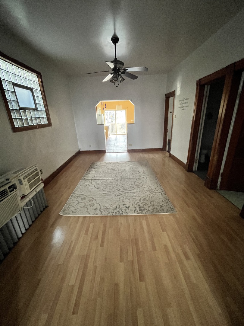 2913 East 97th Street Chicago, IL 60617 - Photo 13 of 16 a view of a livingroom with wooden floor and a window