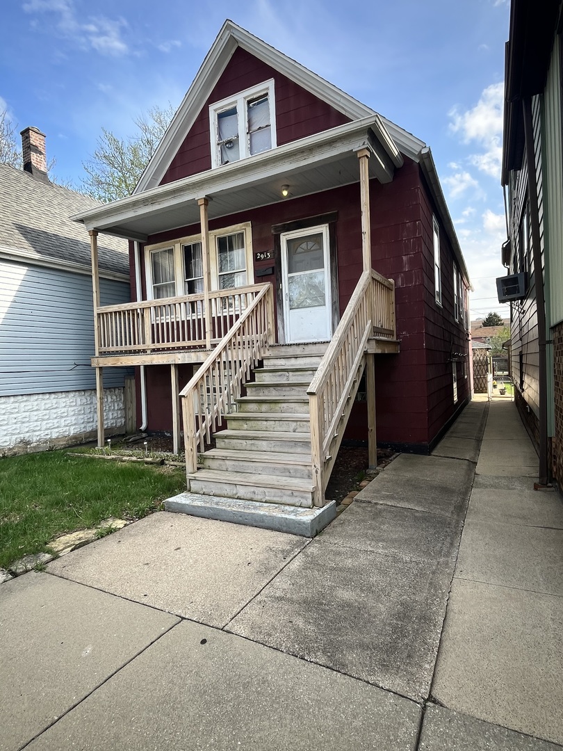 2913 East 97th Street Chicago, IL 60617 - Photo 2 of 16 a front view of a house with a yard