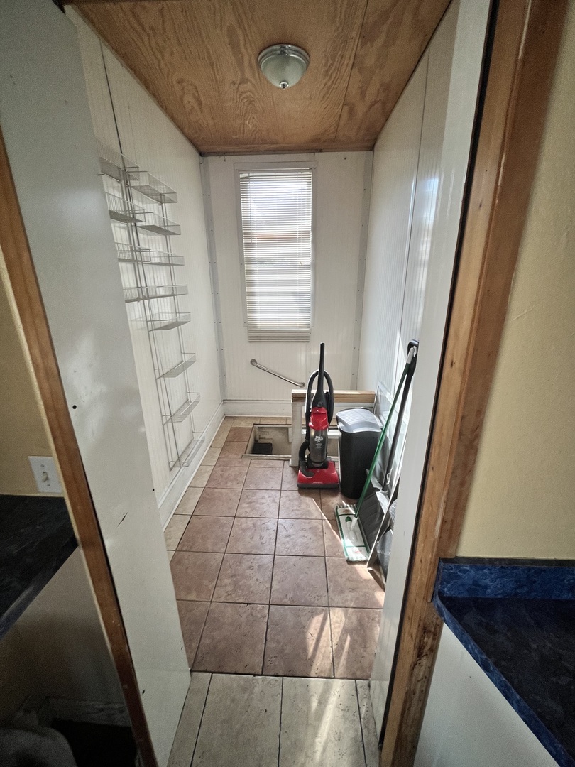 2913 East 97th Street Chicago, IL 60617 - Photo 4 of 16 a view of a living room with furniture and a window