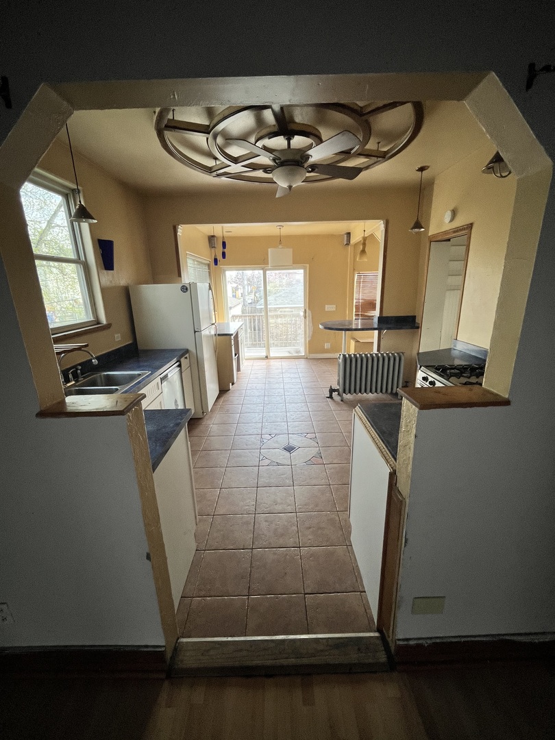2913 East 97th Street Chicago, IL 60617 - Photo 7 of 16 a room with wooden floor and furniture