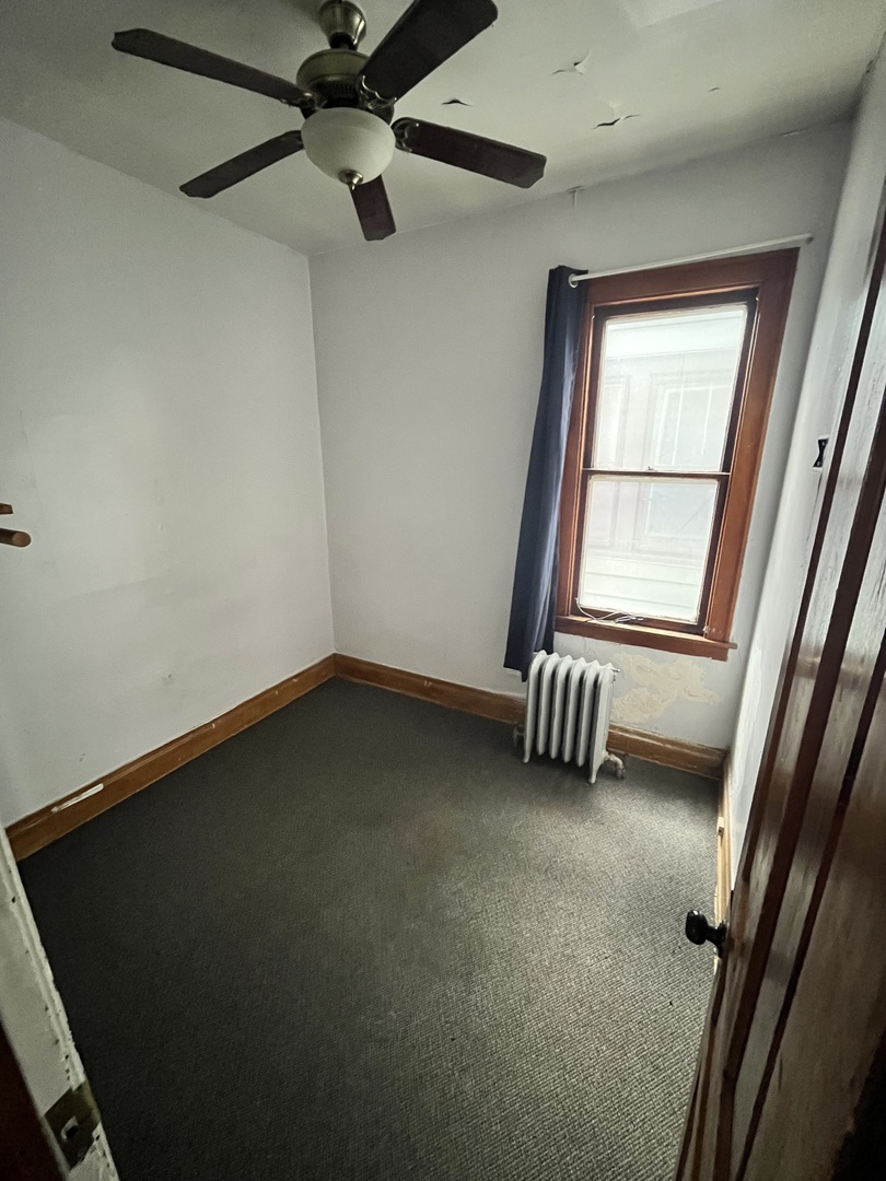 2913 East 97th Street Chicago, IL 60617 - Photo 8 of 16 an empty room with windows