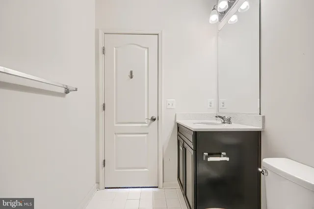 a bathroom with a sink toilet and vanity
