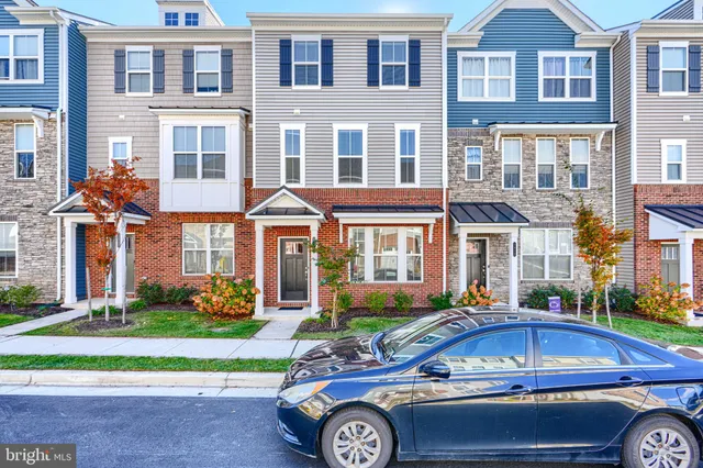 a front view of a residential apartment building with a yard