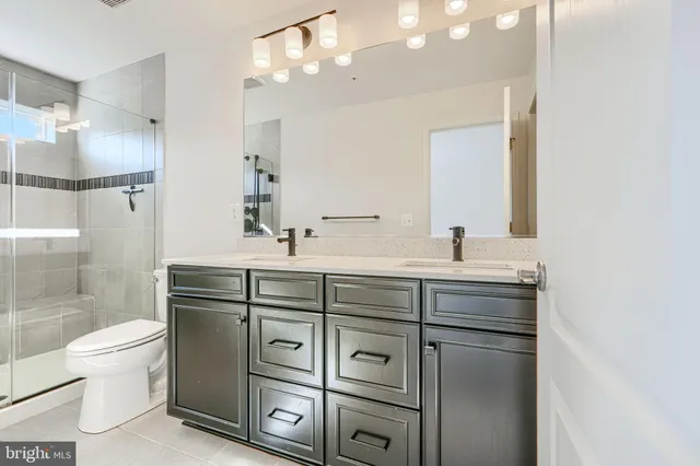 a bathroom with a shower toilet sink and mirror