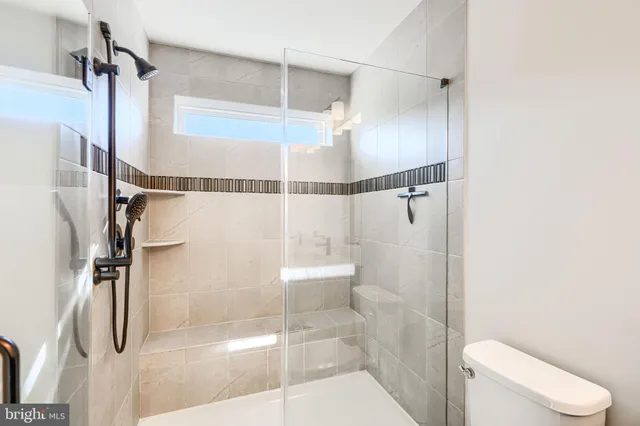 a bathroom with a shower and a toilet