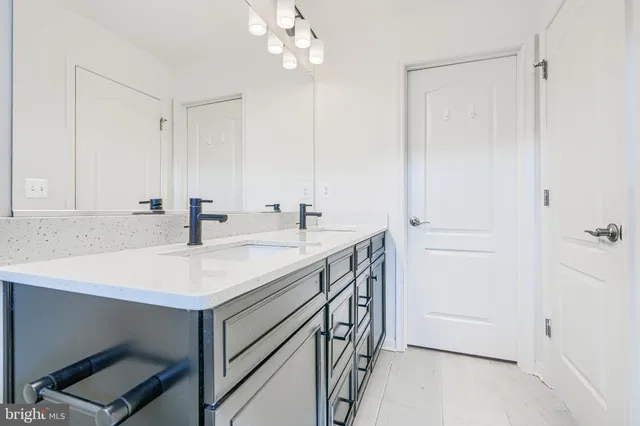 a bathroom with a sink a mirror and a vanity